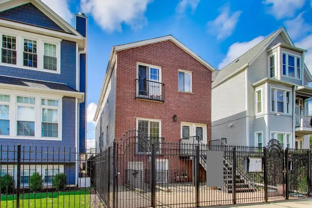 a front view of a residential apartment building with a yard