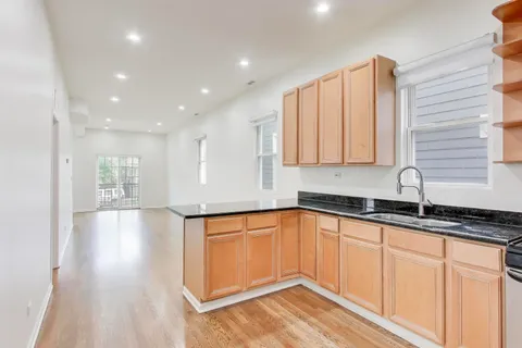 a kitchen with granite countertop a sink and cabinets