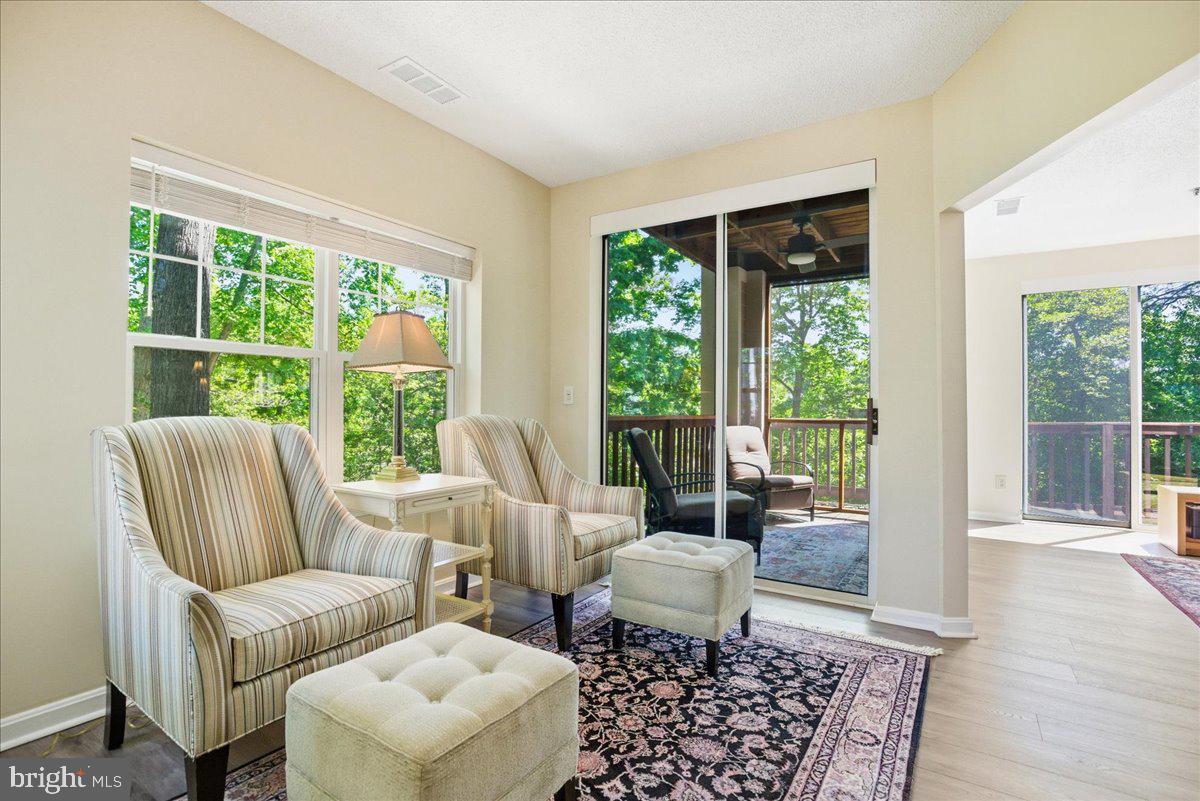 1126 Back Creek Loop, Unit 1126 Solomons, MD 20688 - Photo 25 of 47 a living room with furniture and a window