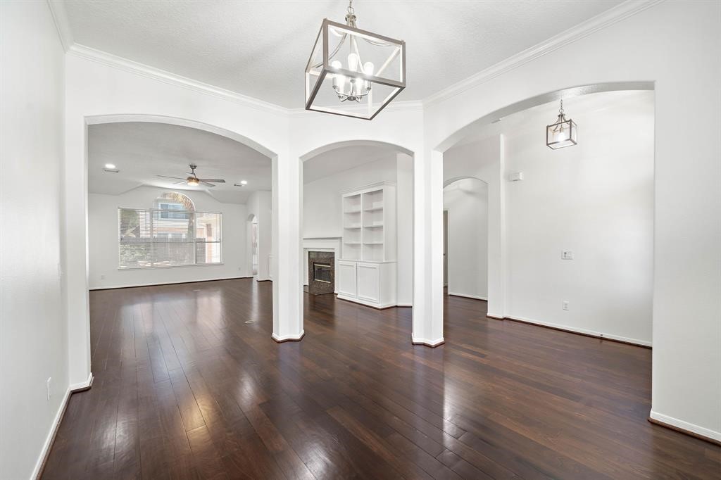 23202 Sawleaf Circle Katy, TX 77494 - Photo 12 of 34 a view of an empty room with wooden floor and a window