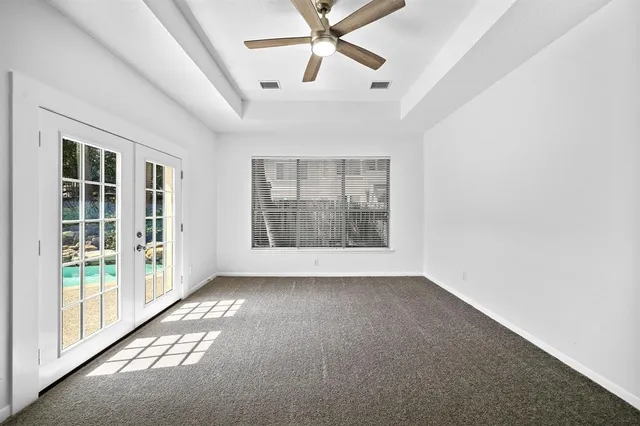 an empty room with windows and entrance