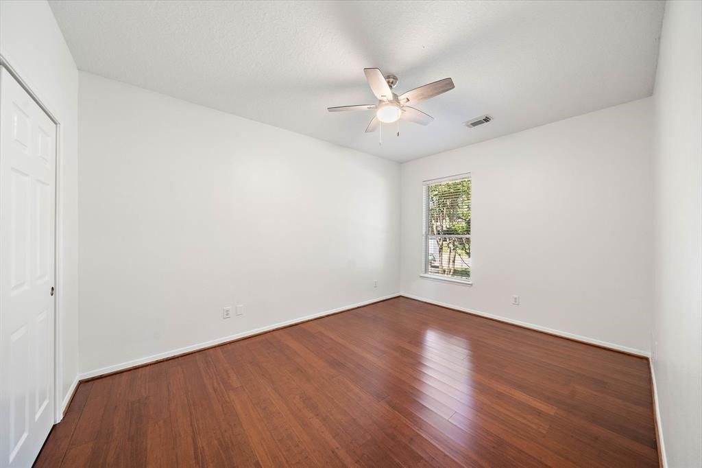23202 Sawleaf Circle Katy, TX 77494 - Photo 30 of 34 an empty room with wooden floor fan and windows