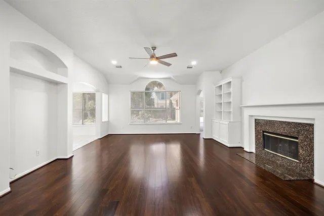 wooden floor in an empty room with a fireplace