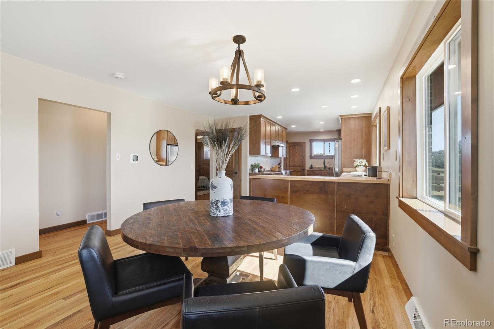 2097 West Wolfensberger Road Castle Rock, CO 80109 - Photo 11 of 48 a view of a dining room with furniture window and wooden floor
