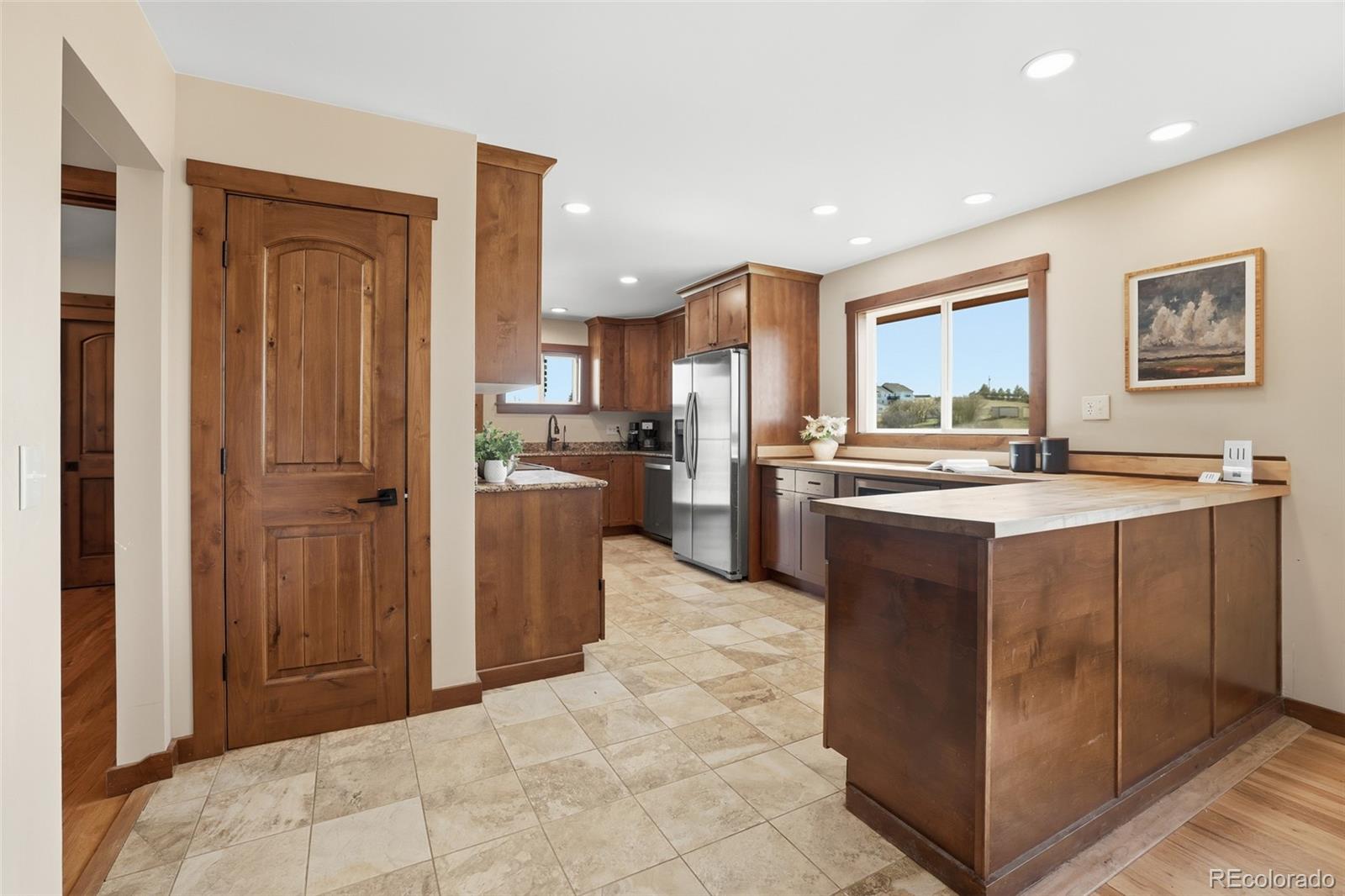 2097 West Wolfensberger Road Castle Rock, CO 80109 - Photo 13 of 48 a kitchen with stainless steel appliances granite countertop a refrigerator a stove and a sink