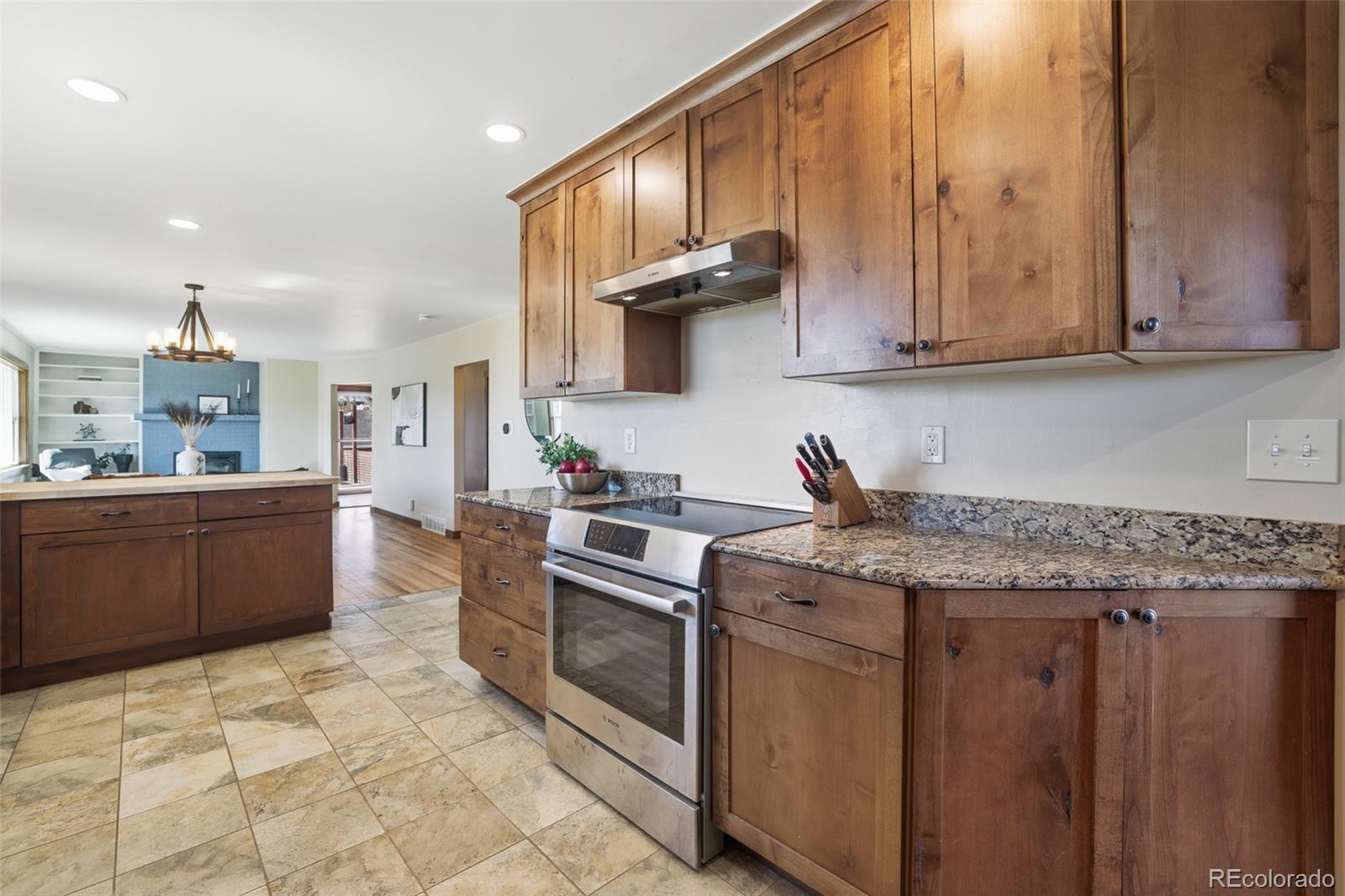 2097 West Wolfensberger Road Castle Rock, CO 80109 - Photo 16 of 48 a kitchen with stainless steel appliances granite countertop a sink stove and cabinets