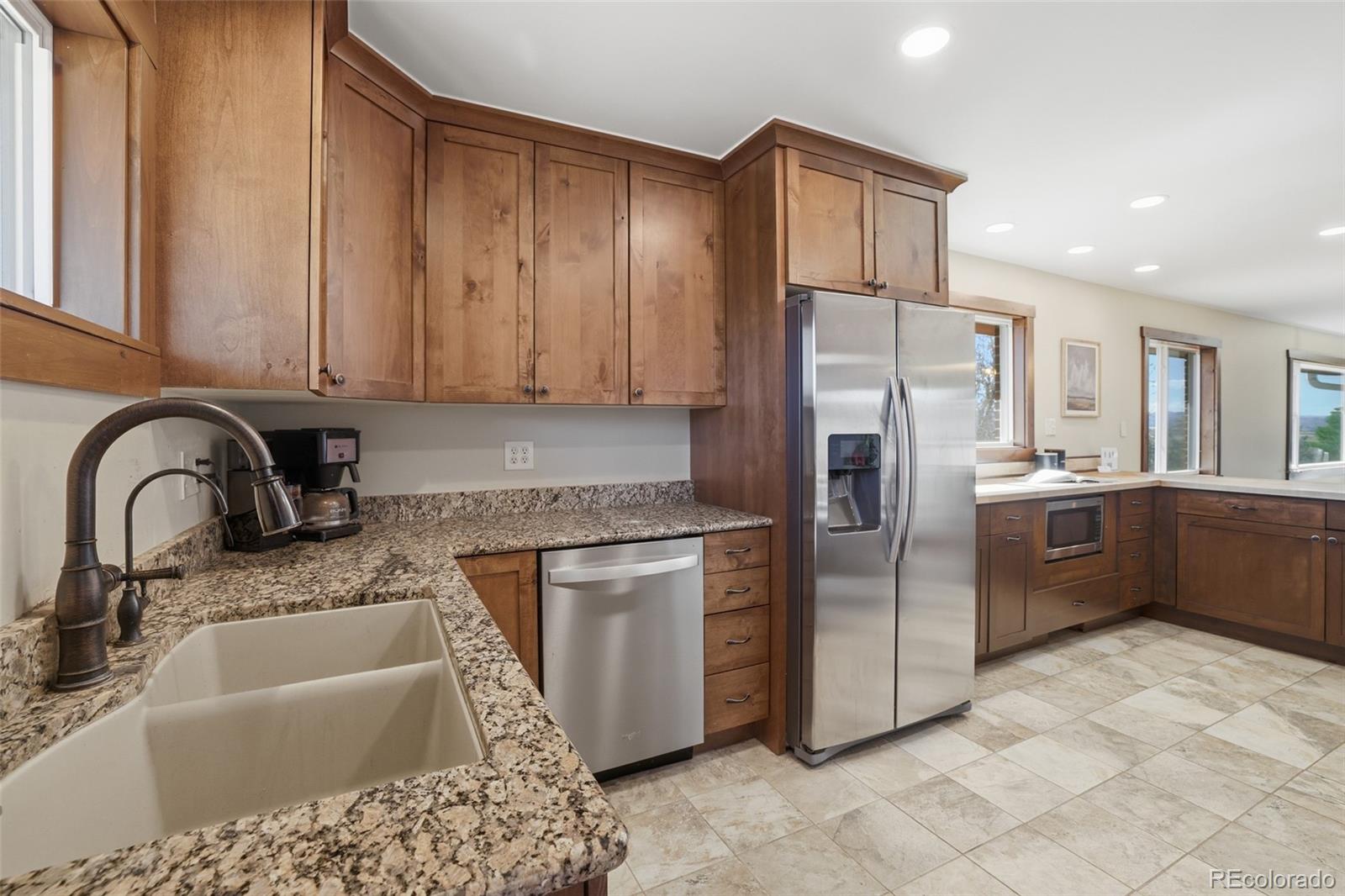 2097 West Wolfensberger Road Castle Rock, CO 80109 - Photo 17 of 48 a kitchen with stainless steel appliances granite countertop a sink stove and refrigerator
