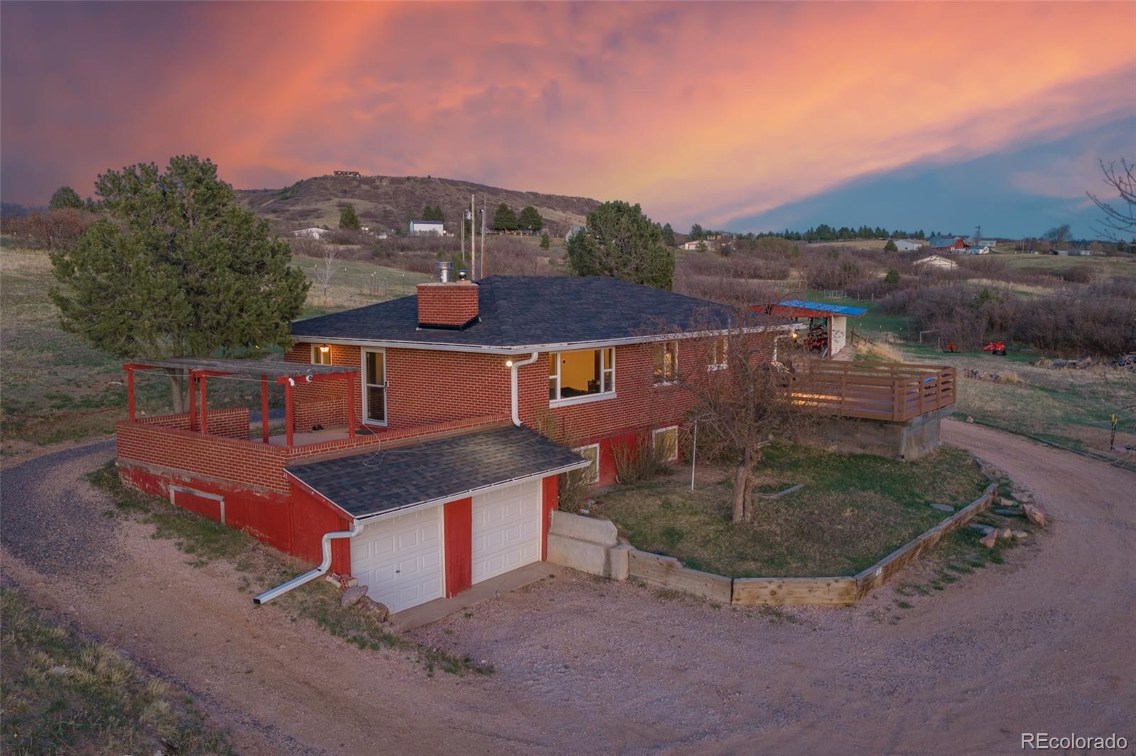 2097 West Wolfensberger Road Castle Rock, CO 80109 - Photo 2 of 48 an aerial view of a house with yard and mountain view