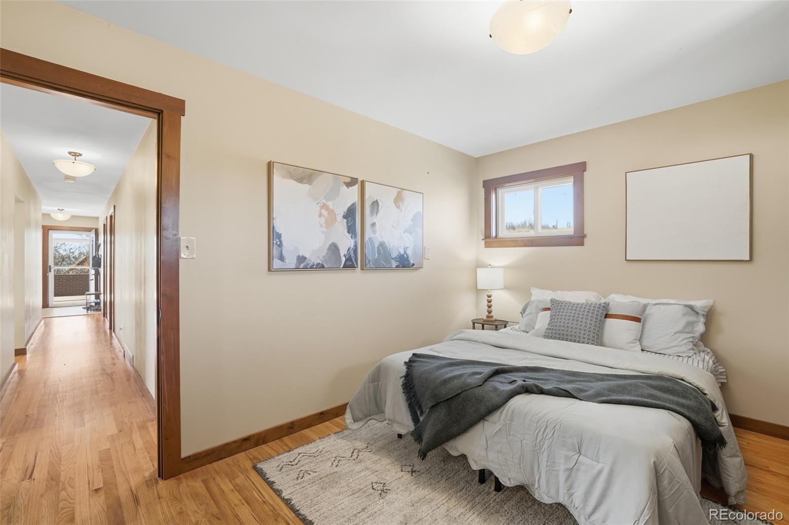 2097 West Wolfensberger Road Castle Rock, CO 80109 - Photo 21 of 48 a bedroom with a bed and a painting on the wall