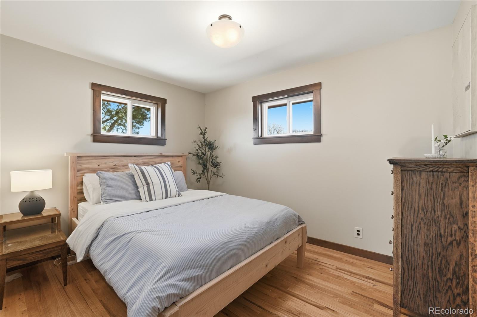 2097 West Wolfensberger Road Castle Rock, CO 80109 - Photo 23 of 48 a bedroom with a bed and a painting on the wall