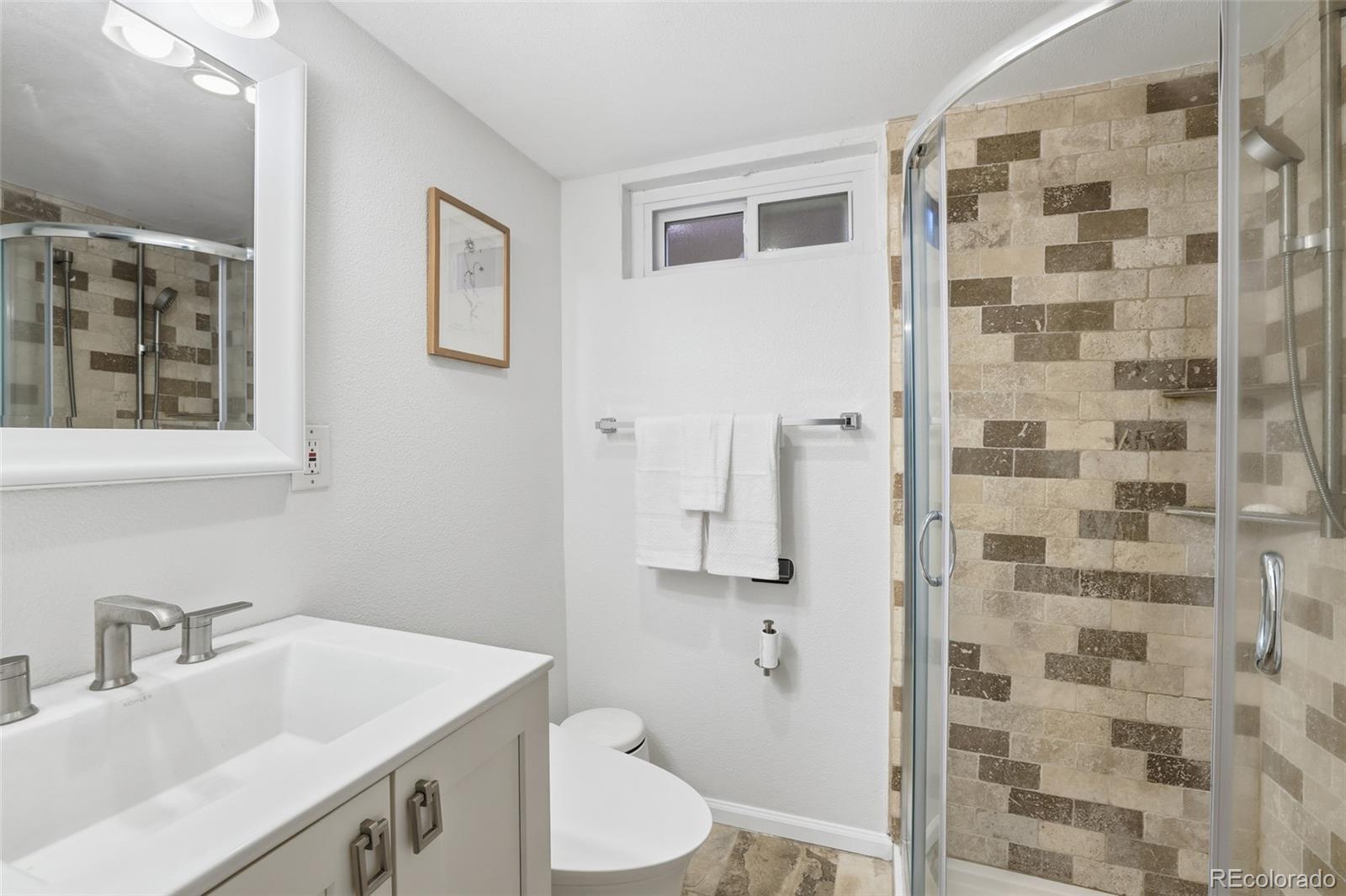 2097 West Wolfensberger Road Castle Rock, CO 80109 - Photo 31 of 48 a bathroom with a sink toilet and shower