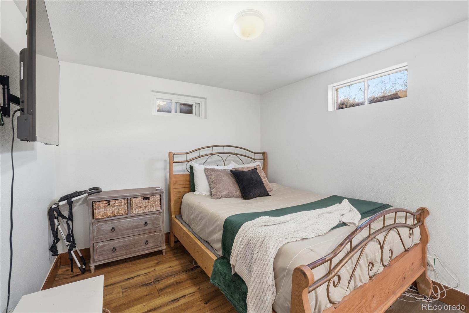 2097 West Wolfensberger Road Castle Rock, CO 80109 - Photo 32 of 48 a bedroom with a bed and wooden floor