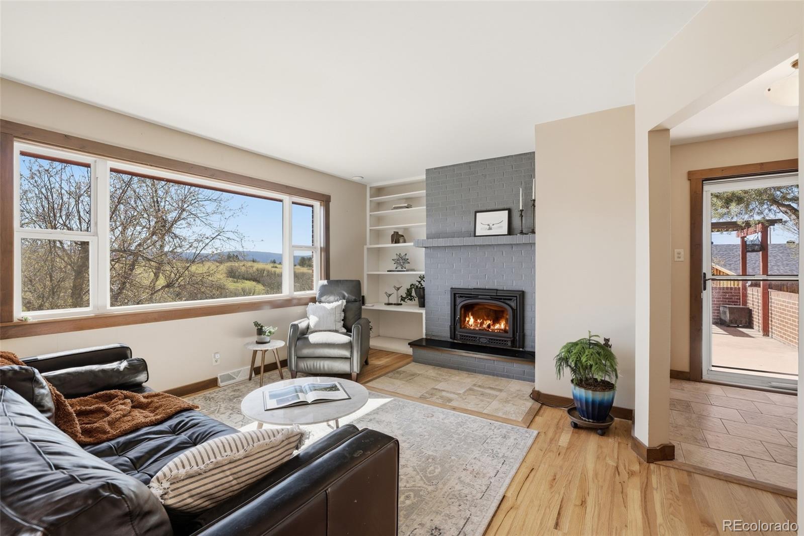 2097 West Wolfensberger Road Castle Rock, CO 80109 - Photo 8 of 48 a living room with furniture and a fireplace