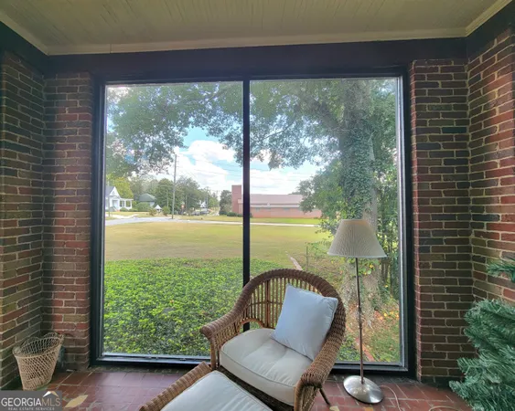 a view of a living room and floor to ceiling window