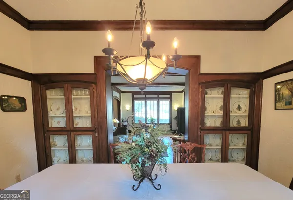a view of a porch with a table and chairs and potted plants