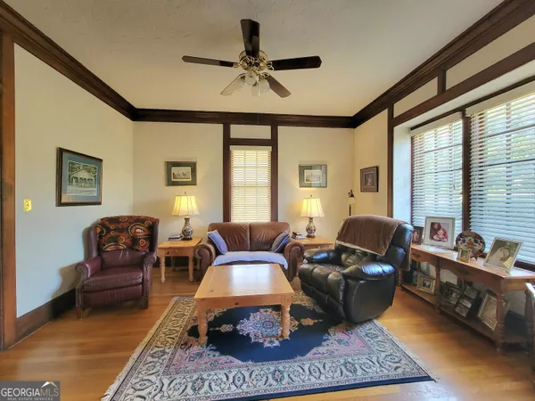 a living room with furniture ceiling fan and a rug