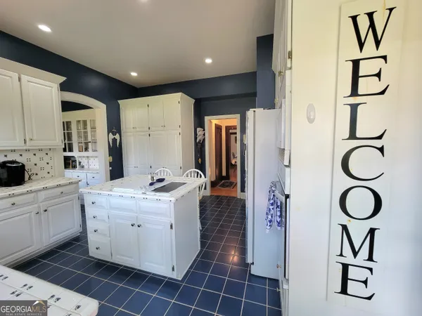 a kitchen with a sink appliances and cabinets
