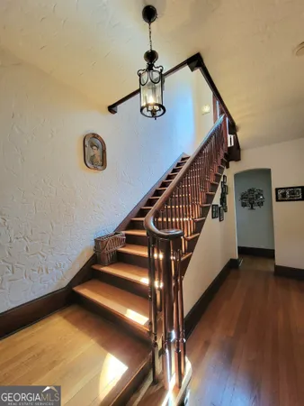 a view of entryway and hall with wooden floor