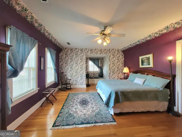 a bedroom with a large bed and a chandelier
