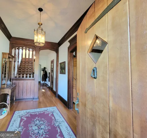 a view of entryway and hall with wooden floor