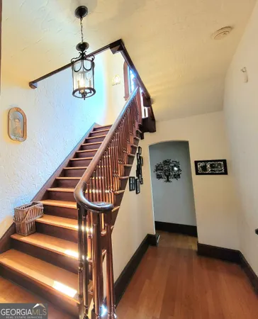 a view of entryway and hall with wooden floor
