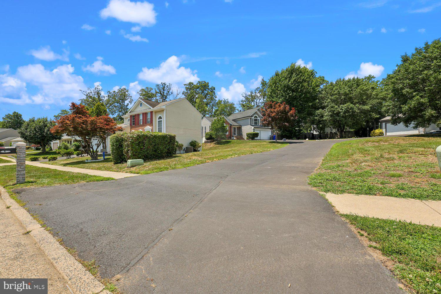 15764 Beau Ridge Drive Woodbridge, VA 22193 - Photo 52 of 58 a front view of a house with a yard and garage