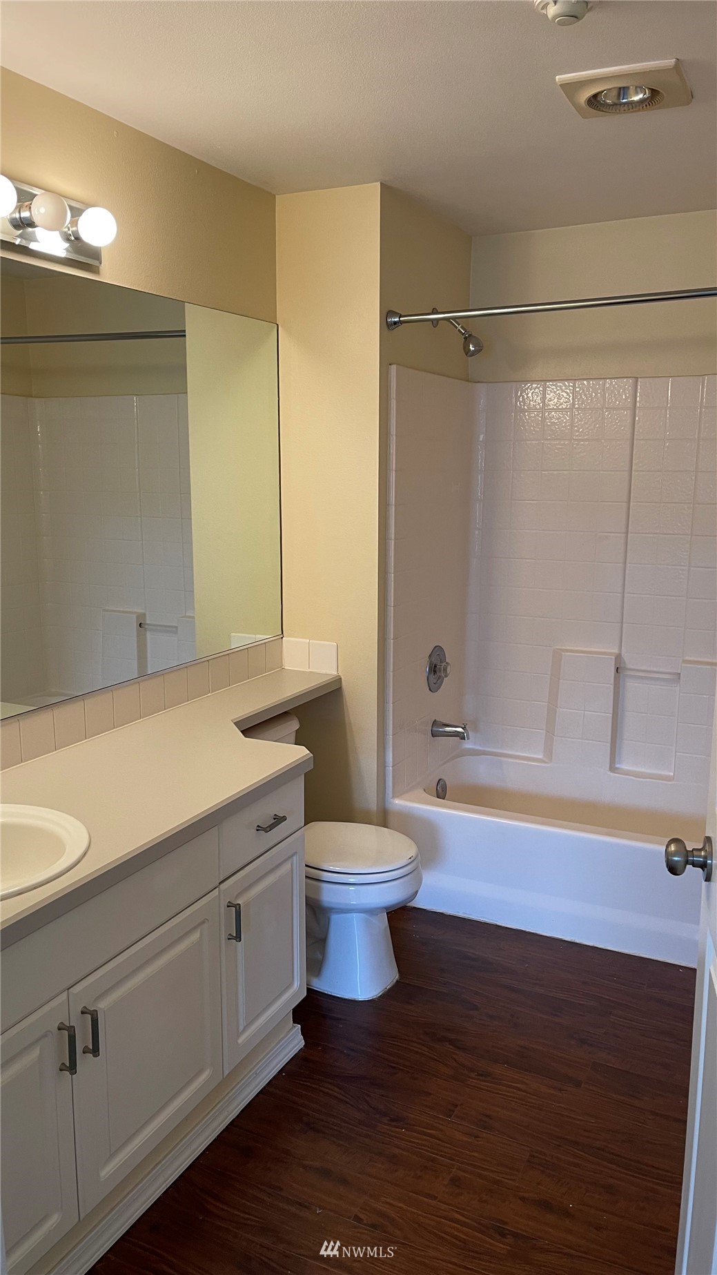 23908 Bothell Everett Highway, Unit B103 Bothell, WA 98021 - Photo 12 of 15 a bathroom with a granite countertop sink a toilet a mirror and shower