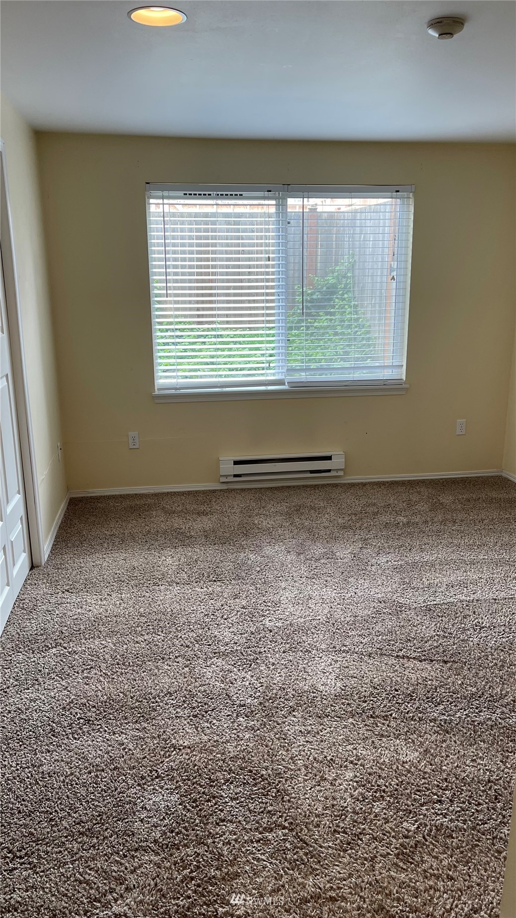 23908 Bothell Everett Highway, Unit B103 Bothell, WA 98021 - Photo 10 of 15 an empty room with wooden floor and a window