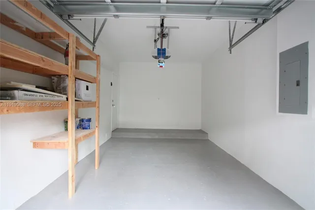 a kitchen with stainless steel appliances kitchen island granite countertop a refrigerator and a sink