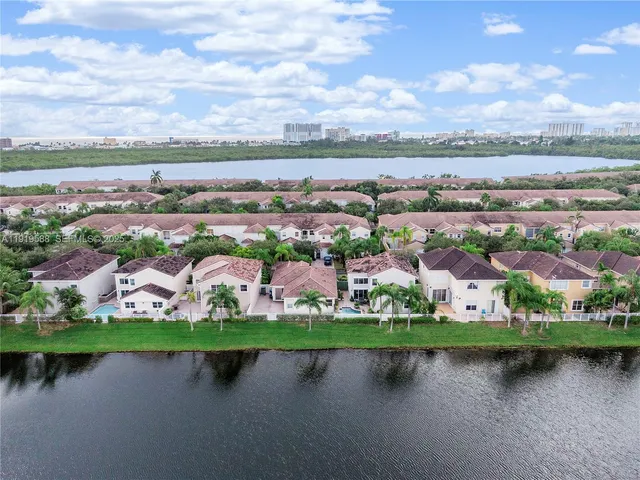 a bench sitting on a pier next to a lake