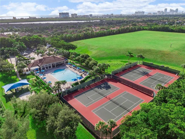 a view of tennis court with houses