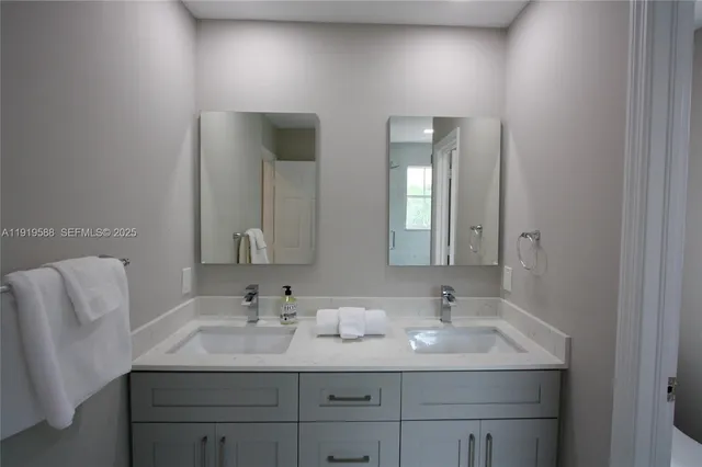 a bathroom with 2 sink and a mirror