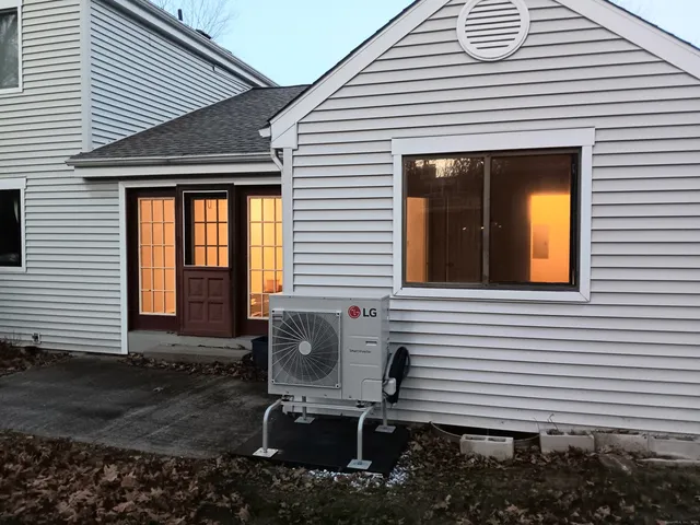 a front view of a house with sitting area