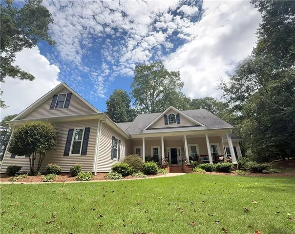 a front view of a house with yard porch and green space