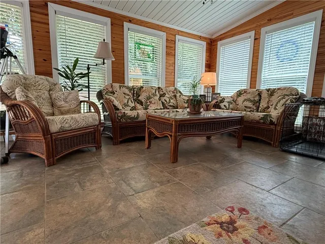 a living room with furniture and large windows
