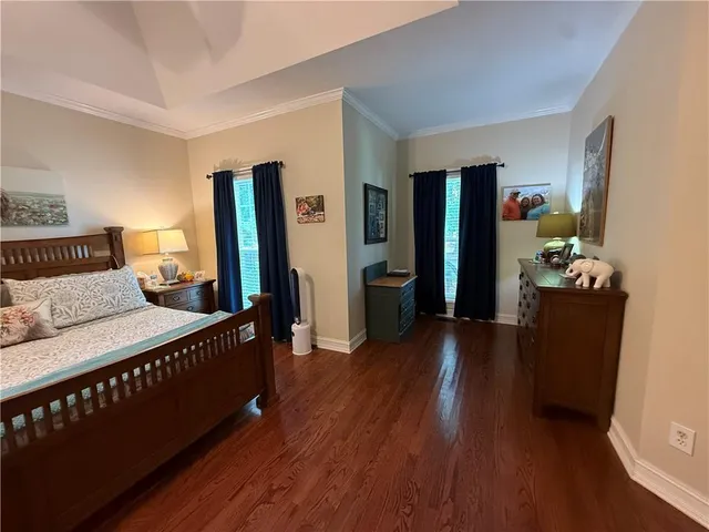 a bedroom with furniture and wooden floor