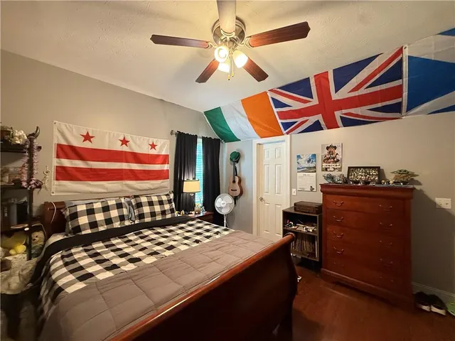 a bedroom with a bed and a chandelier