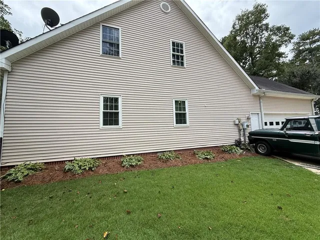 a view of a house with a yard and a garden
