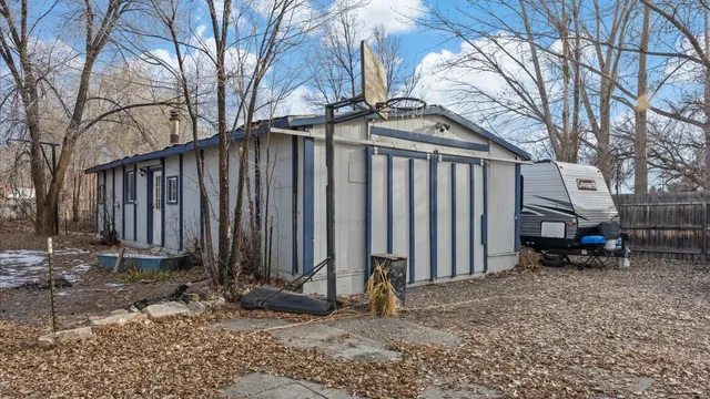 a view of a house with a yard and wooden fence