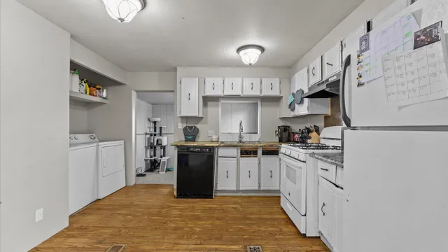 a kitchen with stainless steel appliances granite countertop a stove a sink and a refrigerator