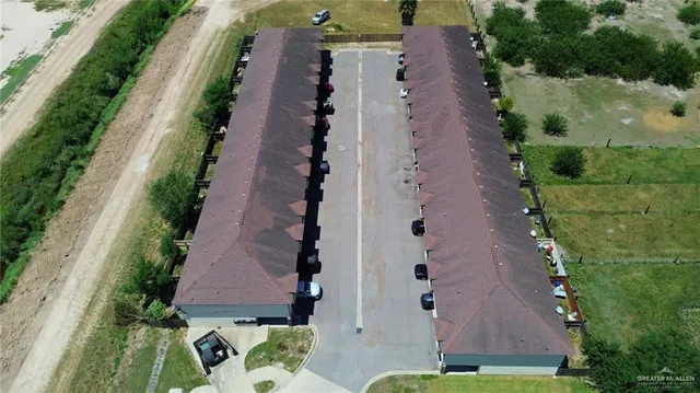 an aerial view of a house with a yard