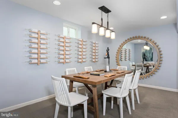 a dining room with furniture a chandelier and wooden floor