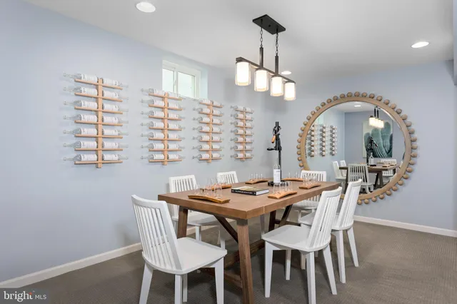 a dining room with furniture a chandelier and wooden floor