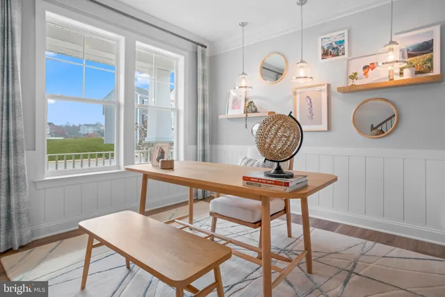 a view of a room with a table and chairs