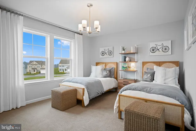 a spacious bedroom with two beds and a window