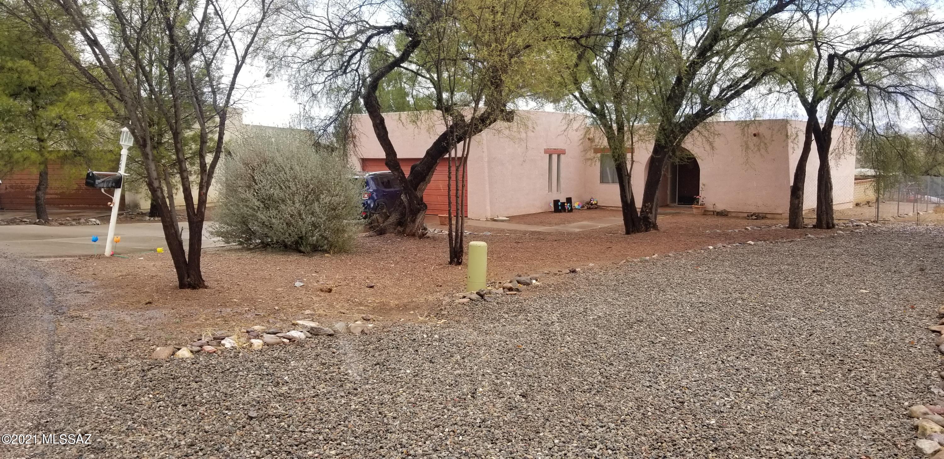 487 Feather Court Rio Rico, AZ 85648 - Photo 1 of 1 a view of a tree in the middle of a yard