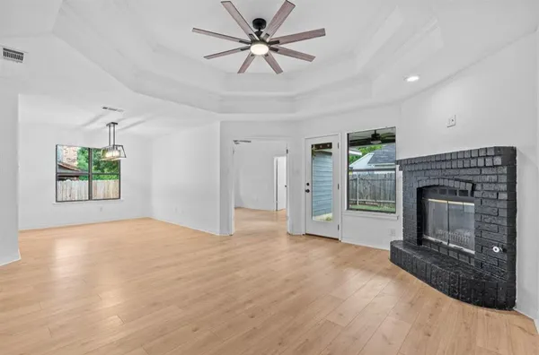 a view of empty room with a fireplace and fan
