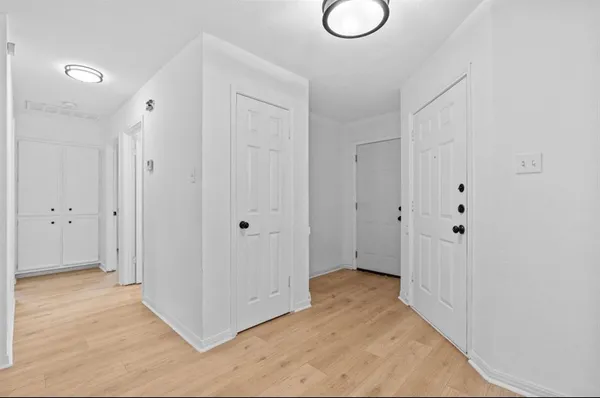 a view of a room with wooden floor