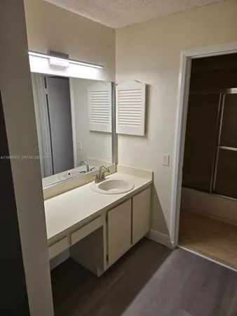 a bathroom with a sink and mirror