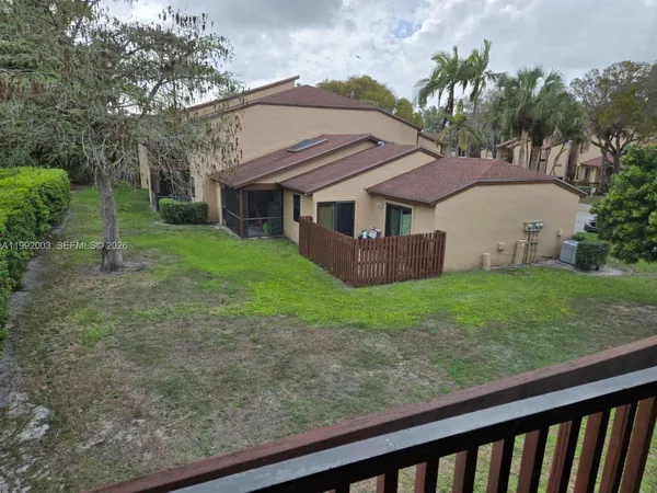 a view of a house with yard and a garden
